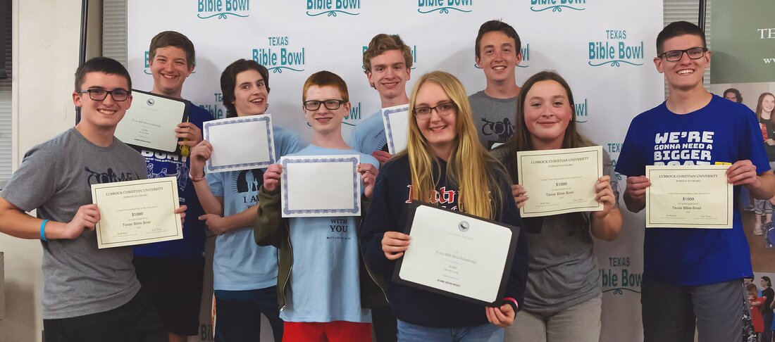 Teen scholarship winners holding certificates in front of the Texas Bible Bowl backdrop