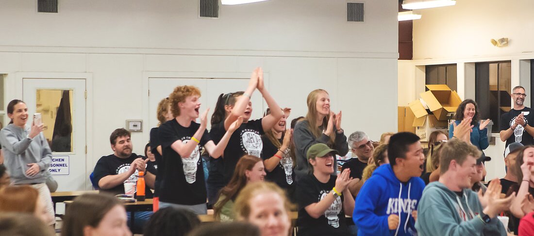 Students in Texas Bible Bowl t-shirts jump and cheer at the awards ceremony