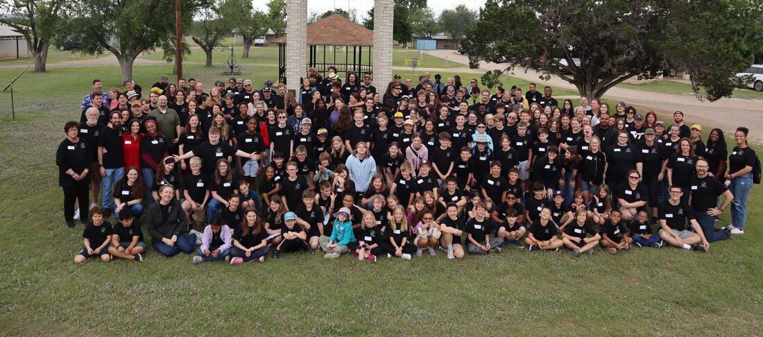 The whole Texas Bible Bowl group gathered on the lawn beneath the camp bell tower